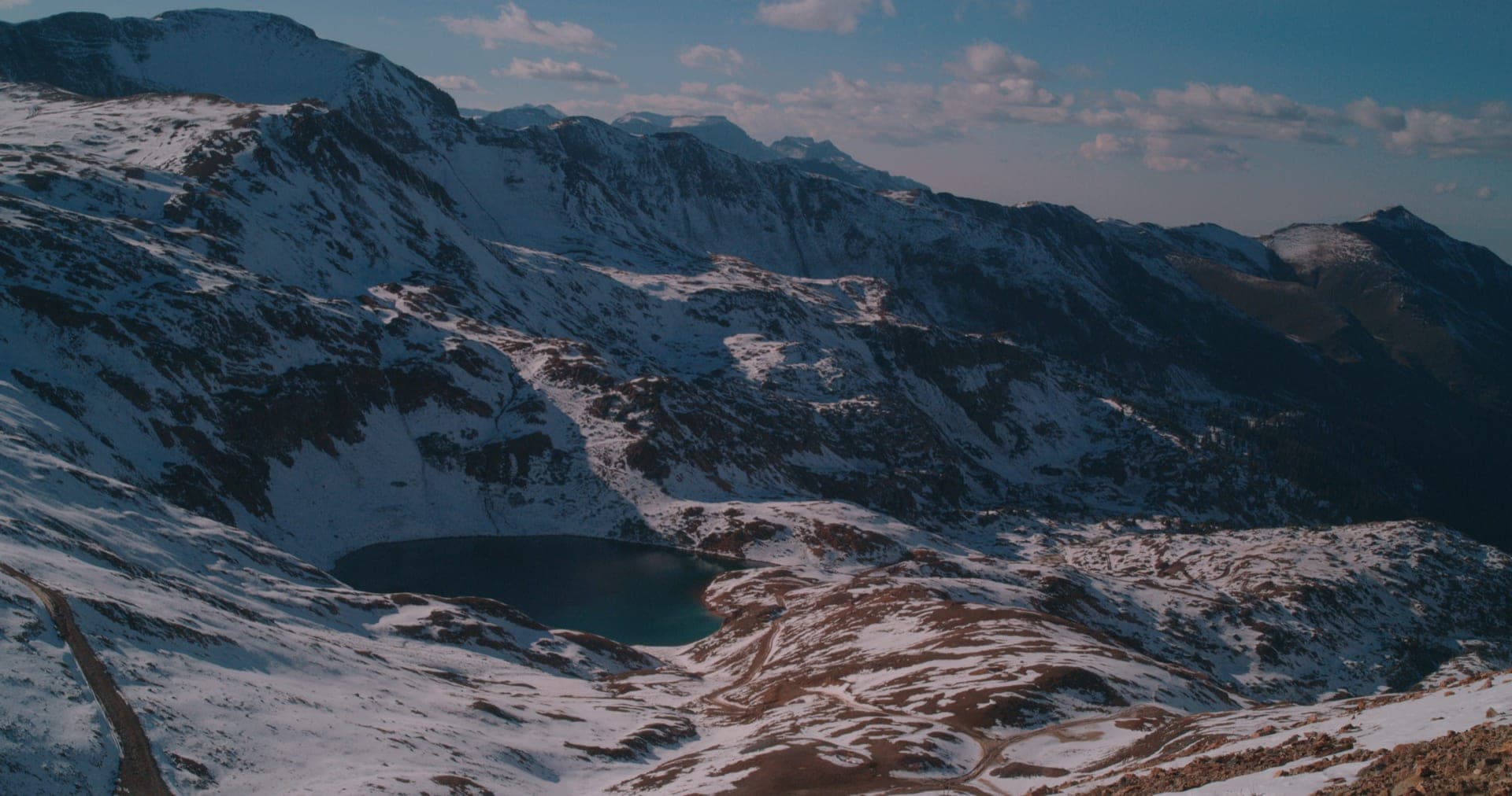 Aerial establishing shot of snow-capped mountains